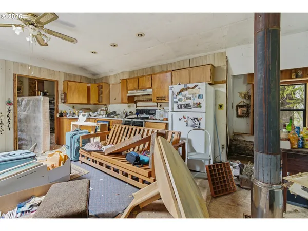 a living room with furniture a flat screen tv and kitchen view