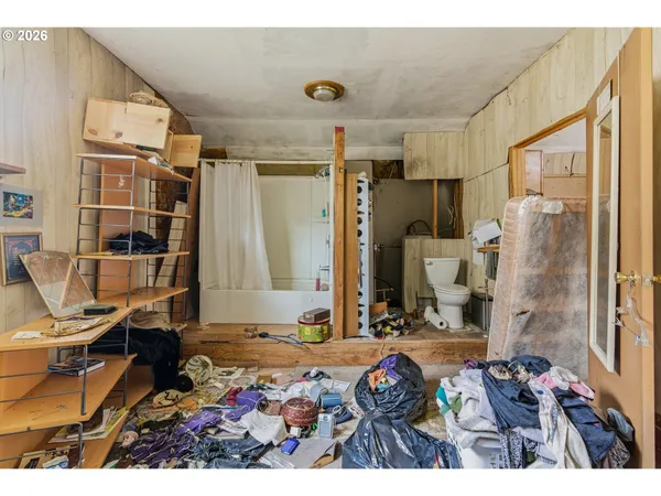 a bedroom with a bed and a desk