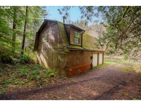 a view of a wooden house with a yard