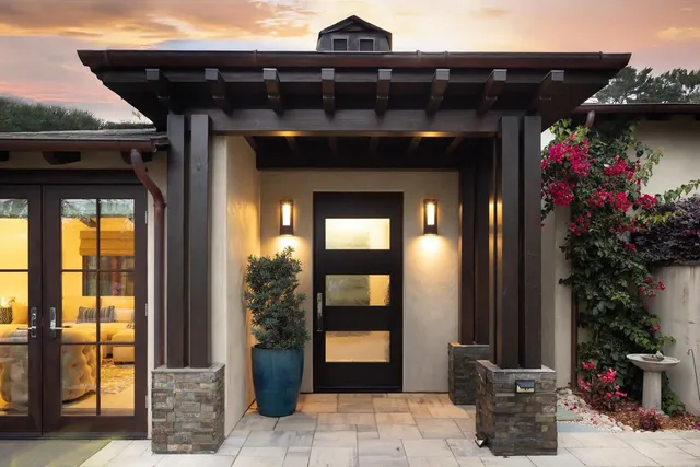 a living room with furniture a flat screen tv and a floor to ceiling window