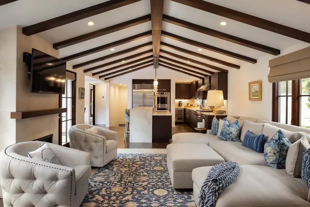 a kitchen with a dining table chairs and wooden floor