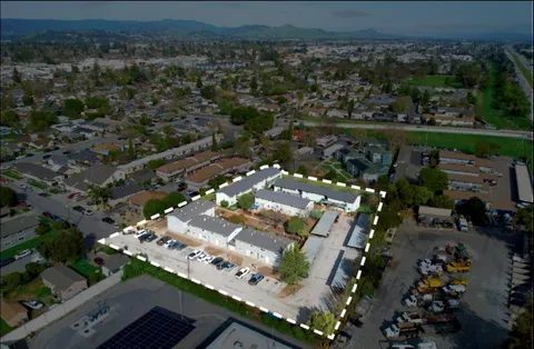 an aerial view of a residential houses with outdoor space