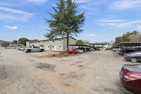 a view of road with card and parked cars
