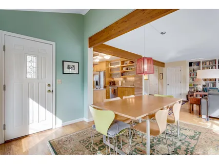 a dining room with furniture and wooden floor