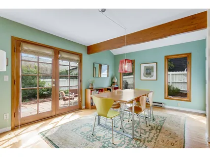 a dining room with furniture and wooden floor