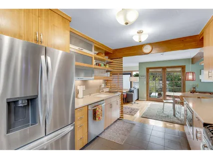 a kitchen with stainless steel appliances granite countertop a refrigerator and a stove