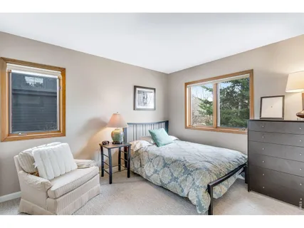 a bedroom with a large bed and a couch