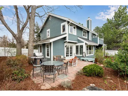 a view of a house with patio and a yard