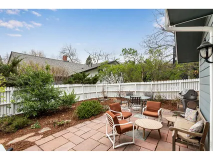 a terrace with outdoor seating and trees