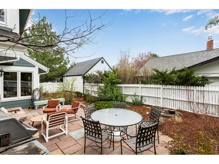 a view of a patio with a table and chairs