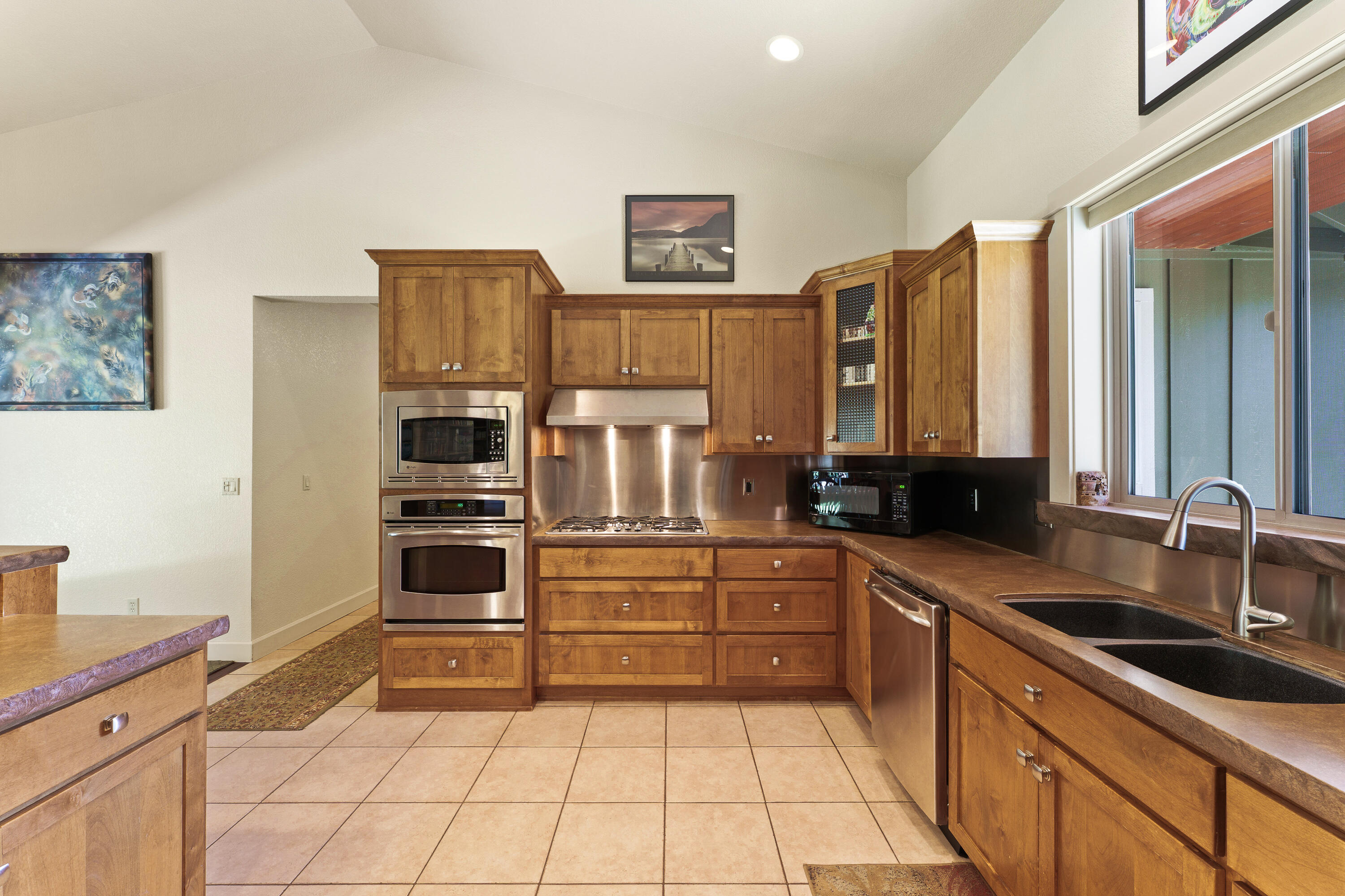 19236 Kiowa Road Bend, OR 97702 - Photo 17 of 52 a kitchen with stainless steel appliances a stove sink and cabinets