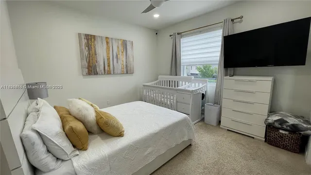 a bedroom with a bed and flat screen tv