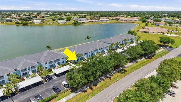 an aerial view of a house with a lake view