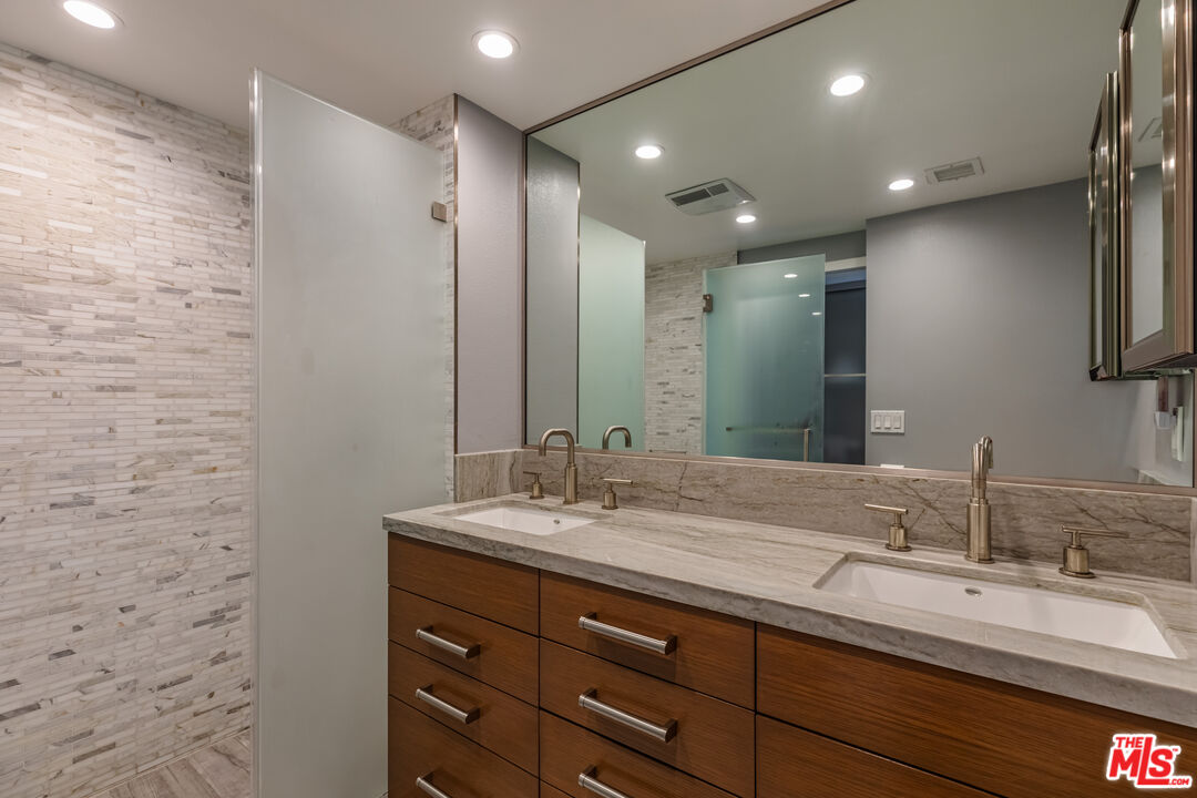 17352 Sunset Boulevard, Unit 202 Pacific Palisades, CA 90272 - Photo 17 of 30 a bathroom with a double vanity sink and a mirror