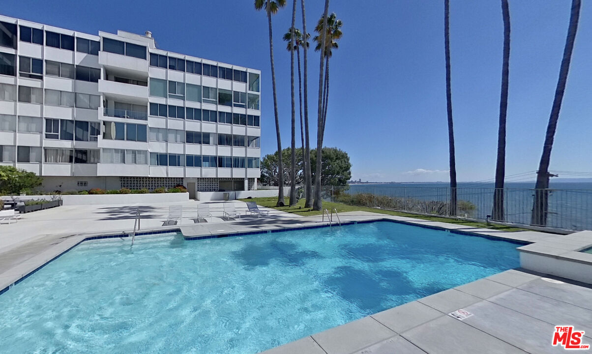 17352 Sunset Boulevard, Unit 202 Pacific Palisades, CA 90272 - Photo 24 of 30 a view of a swimming pool with a lounge chair