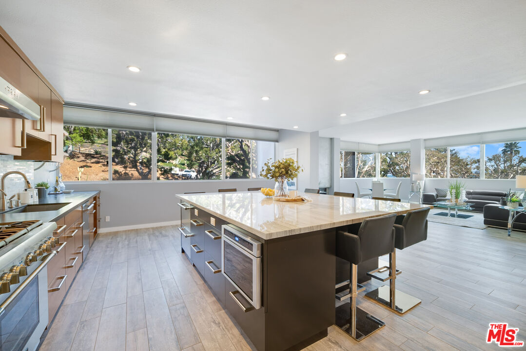 17352 Sunset Boulevard, Unit 202 Pacific Palisades, CA 90272 - Photo 7 of 30 a kitchen with a stove and a wooden floors