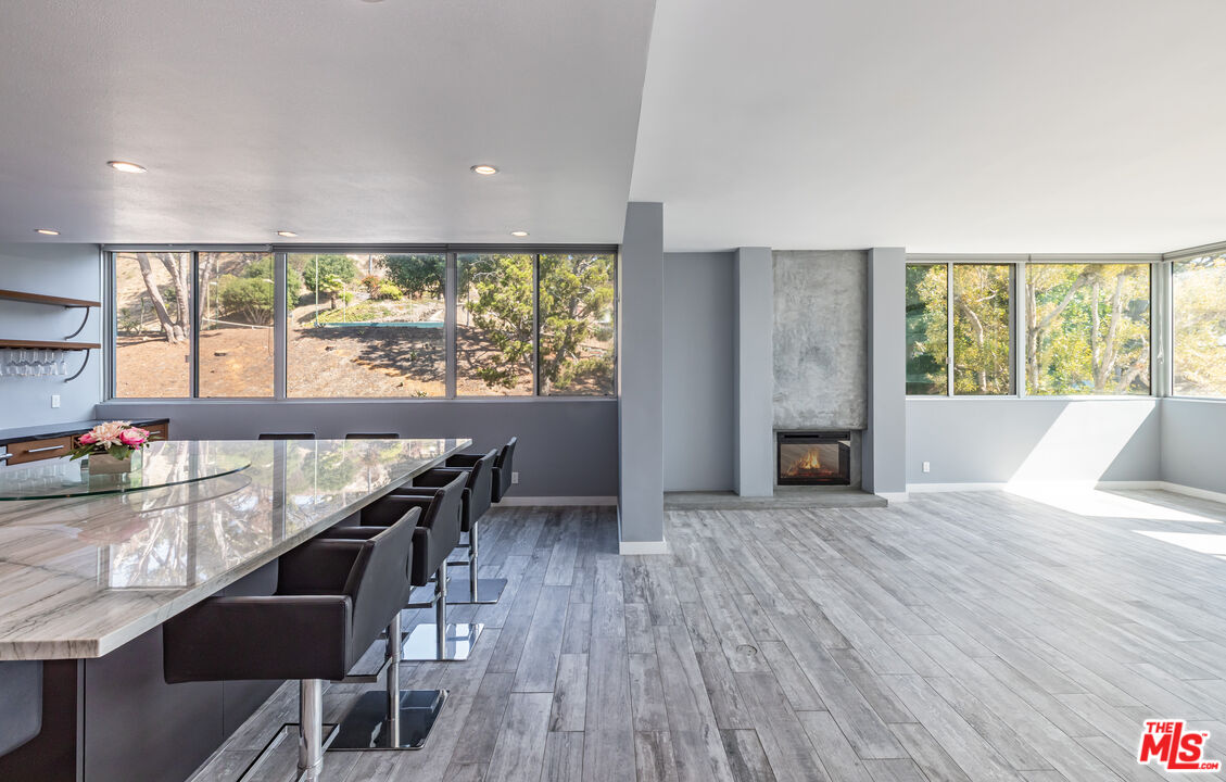 17352 Sunset Boulevard, Unit 202 Pacific Palisades, CA 90272 - Photo 8 of 30 a view of a dining room with furniture window and wooden floor
