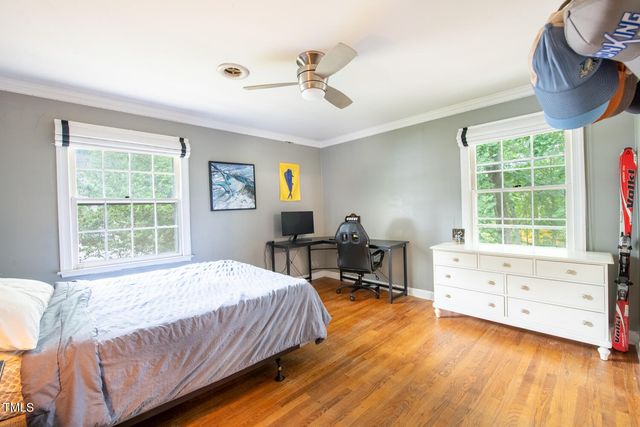a spacious bedroom with a bed and a table in it
