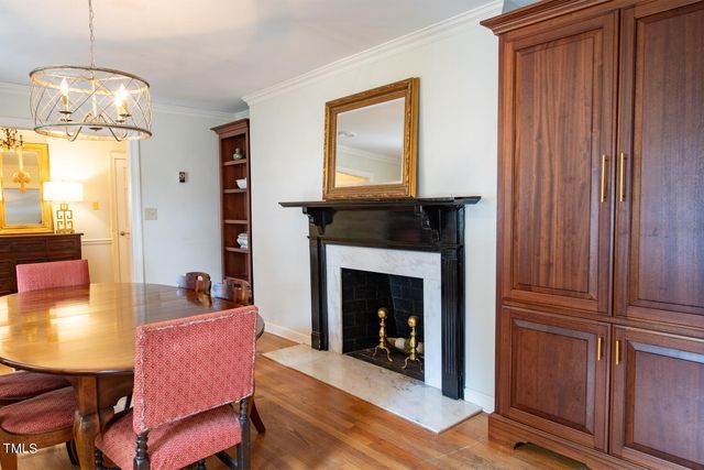 a living room with furniture a fireplace and a window