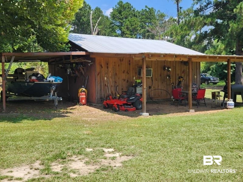 640 Horseshoe Road Brewton, AL 36426 - Photo 20 of 22 Exterior space with a yard and a carport