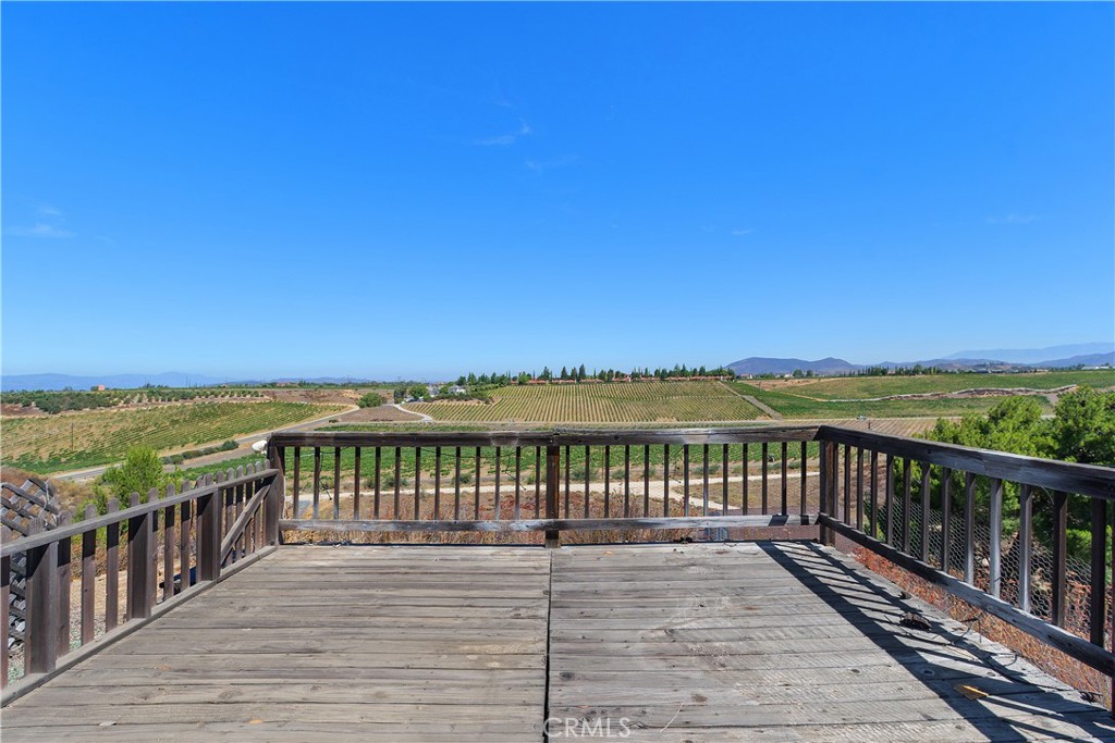 34881 Los Nogales Road Temecula, CA 92592 - Photo 6 of 50 The deck off the front of the home and off the primary bedroom faces the South Coust Winery. See the South Coast cabanas, vineyards and all jsut off Anza Rd.