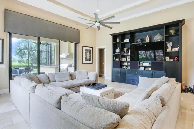 a living room with furniture and large window