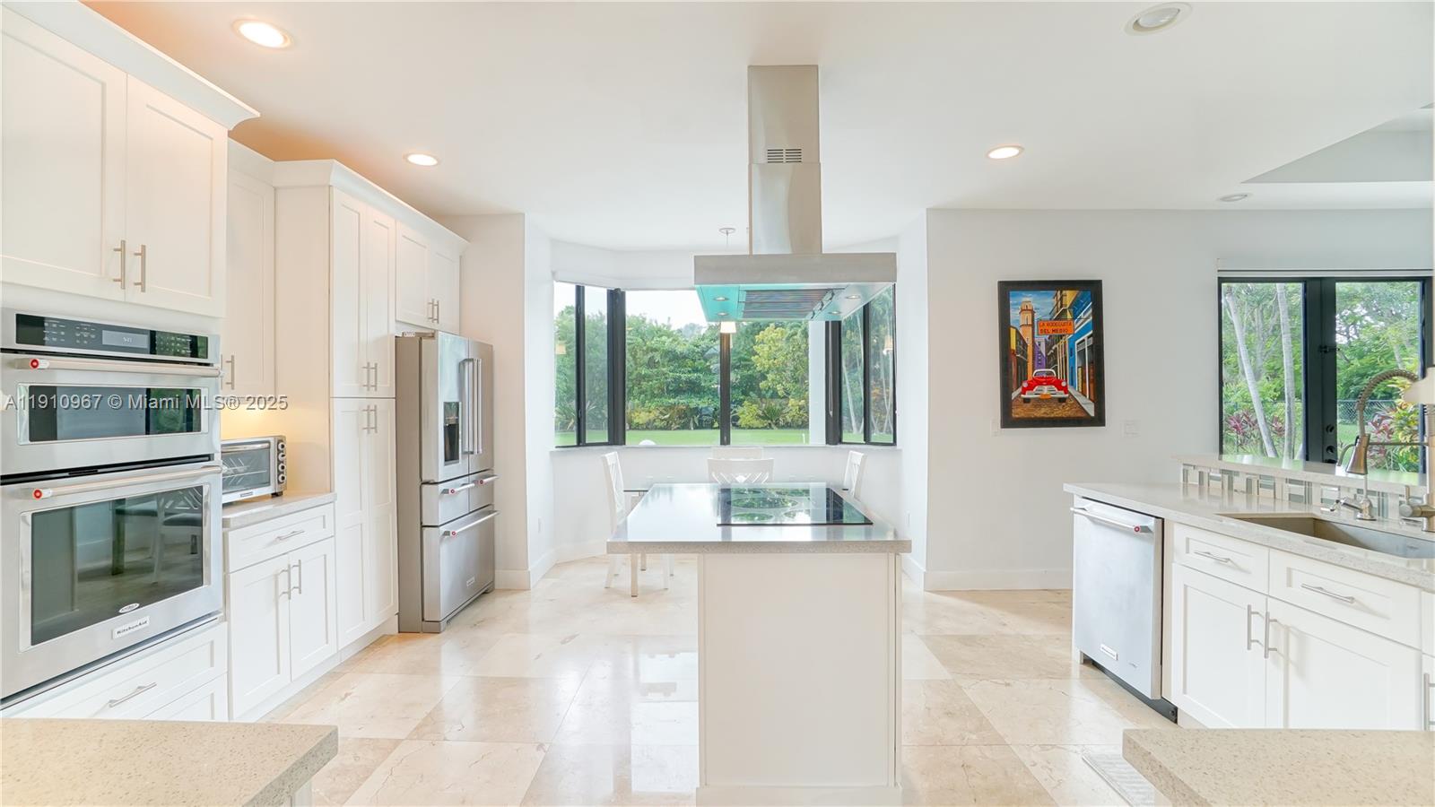 6950 Southwest 97th Avenue Miami, FL 33173 - Photo 18 of 22 a kitchen with stainless steel appliances granite countertop a refrigerator and a stove top oven