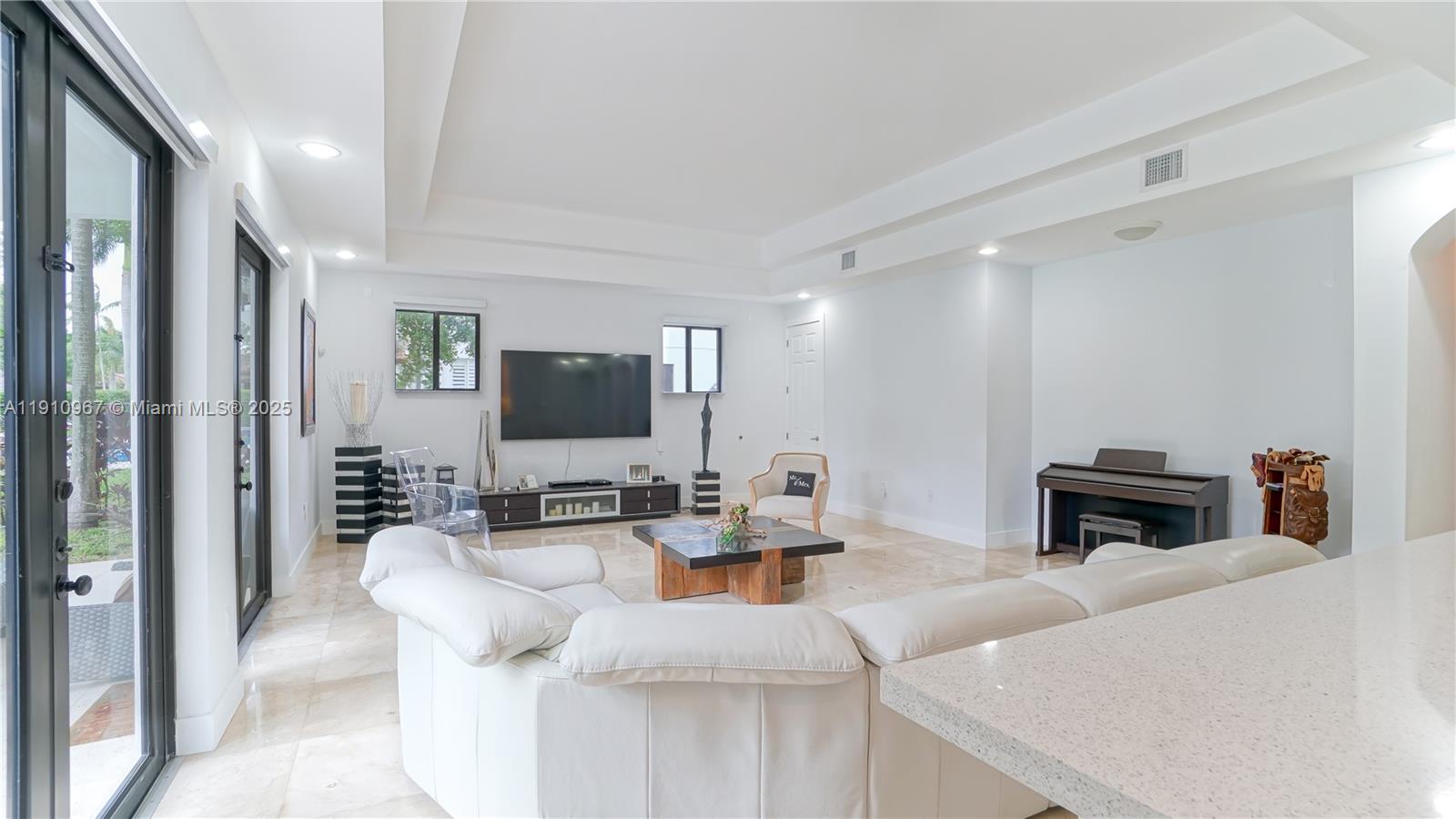 6950 Southwest 97th Avenue Miami, FL 33173 - Photo 20 of 22 a living room with furniture and a flat screen tv