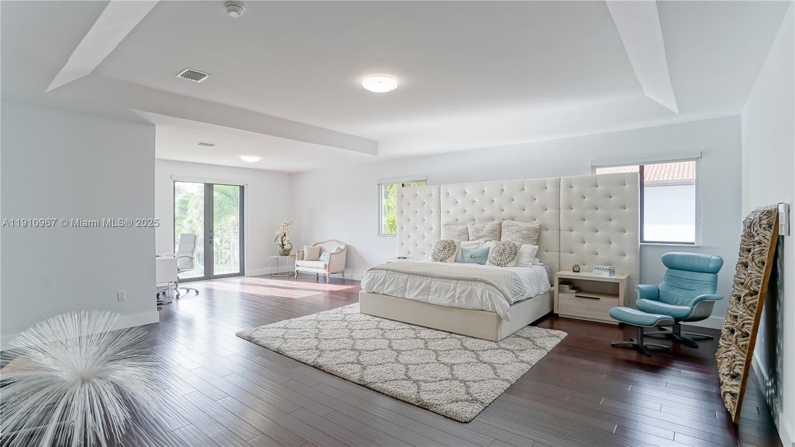 6950 Southwest 97th Avenue Miami, FL 33173 - Photo 22 of 22 a spacious bedroom with a bed and a wooden floor