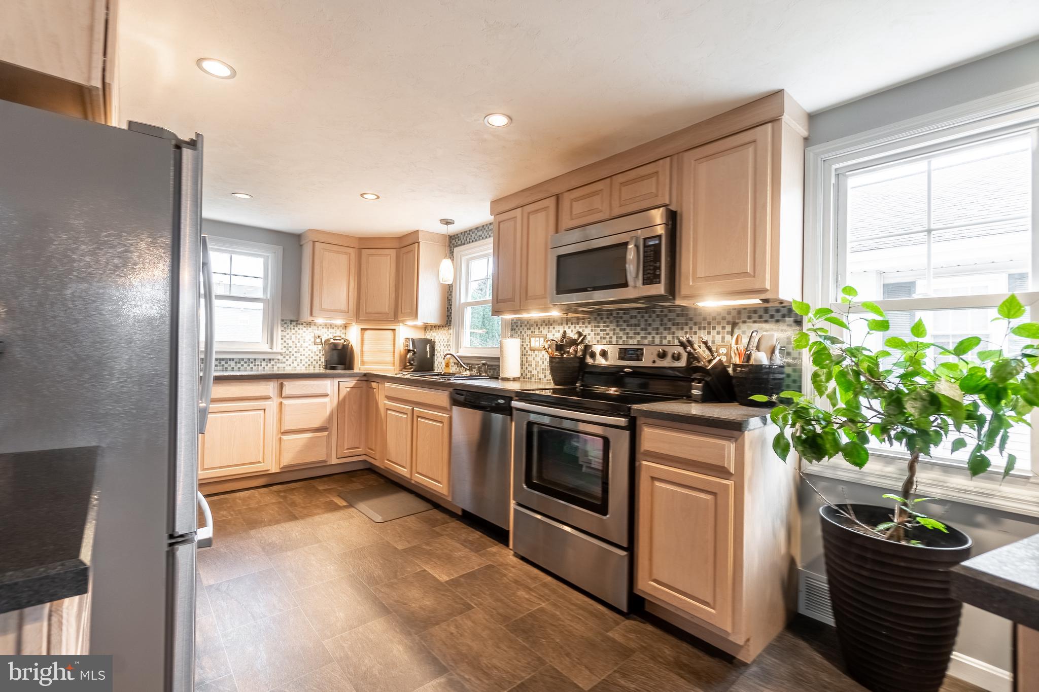 311 Wirt Avenue Hanover, PA 17331 - Photo 6 of 37 a kitchen with granite countertop a refrigerator a stove a sink a counter space and cabinets
