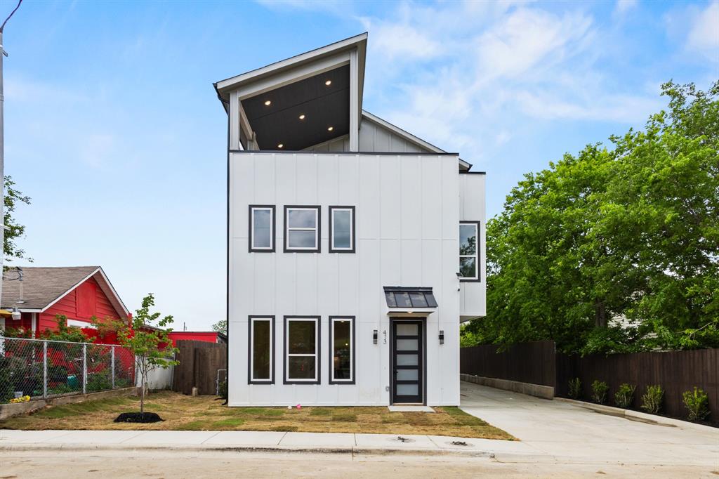 413 North Patton Avenue Dallas, TX 75203 - Photo 4 of 21 a front view of a house with a yard
