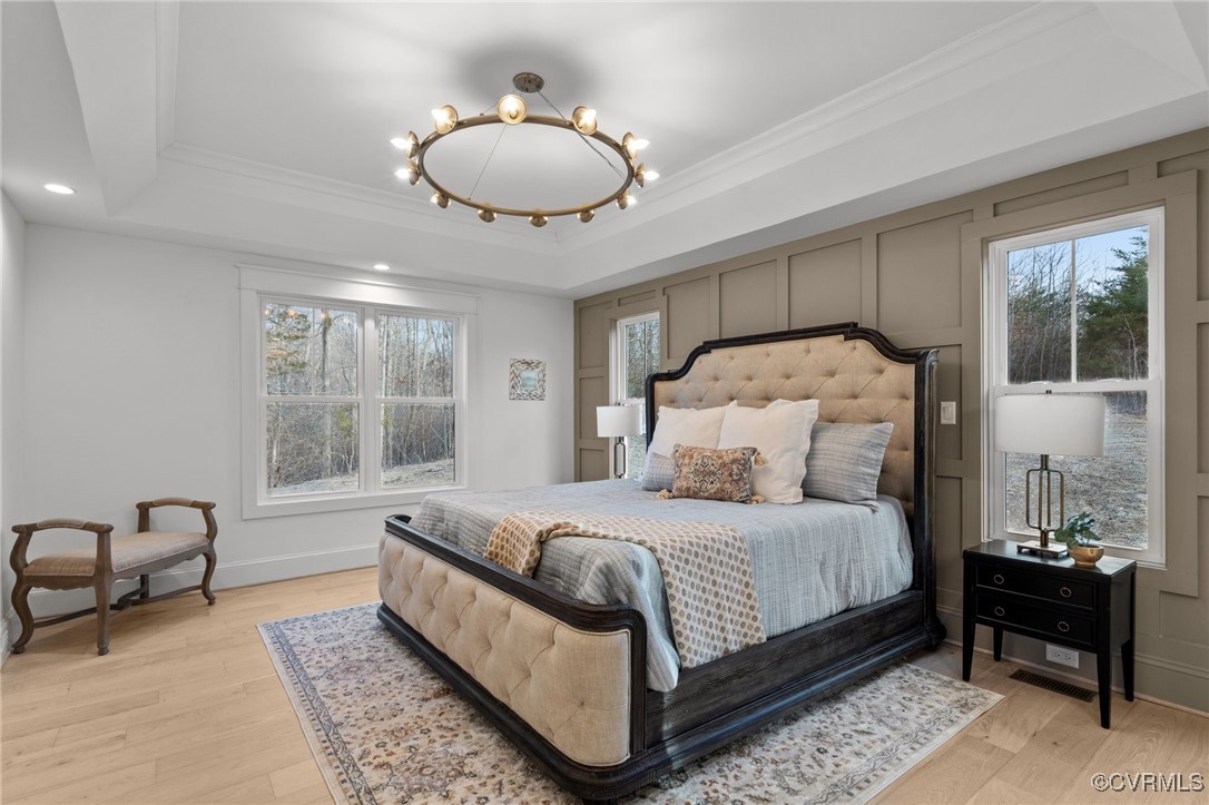 4792 Bell Road Powhatan, VA 23139 - Photo 20 of 27 a bedroom with a large bed and a chandelier