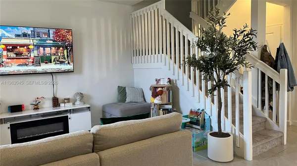 a living room with furniture and lamp