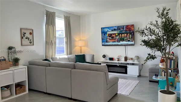 a living room with a couch and a window