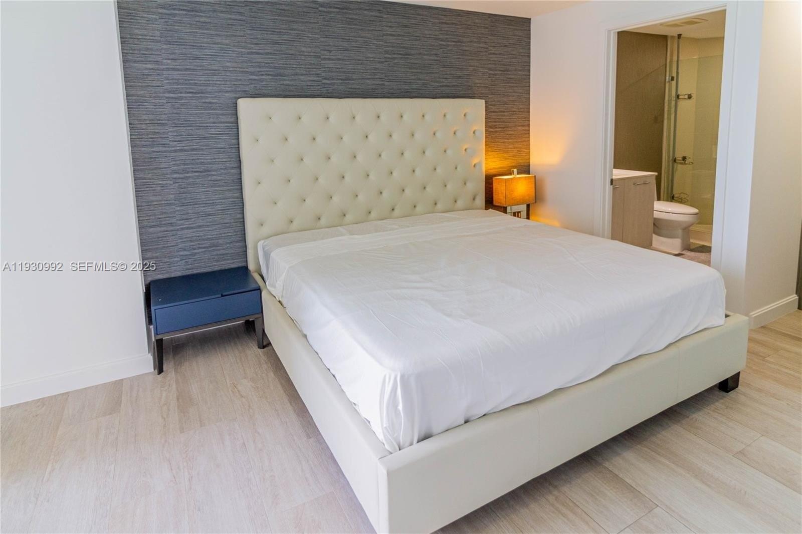 45 Southwest 9th Street, Unit 3601 Miami, FL 33130 - Photo 12 of 19 a bedroom with a bed and a night stand