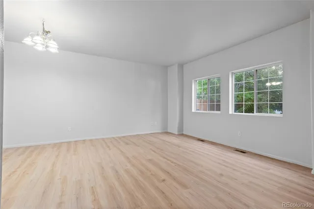 wooden floor in a room next to a window