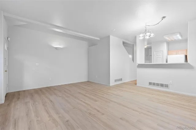 a view of a kitchen with a sink and a mirror