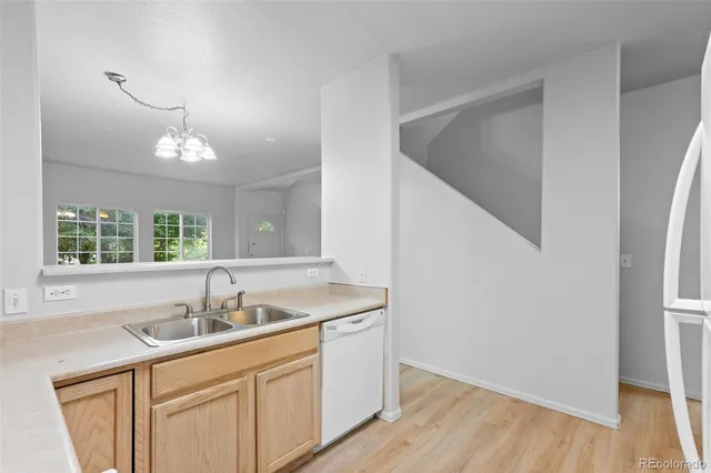 a kitchen with a sink cabinets and a window