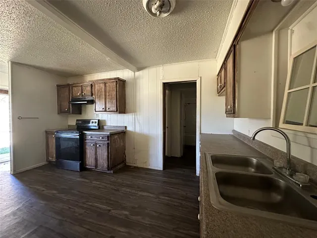 a kitchen with a sink appliances and cabinets