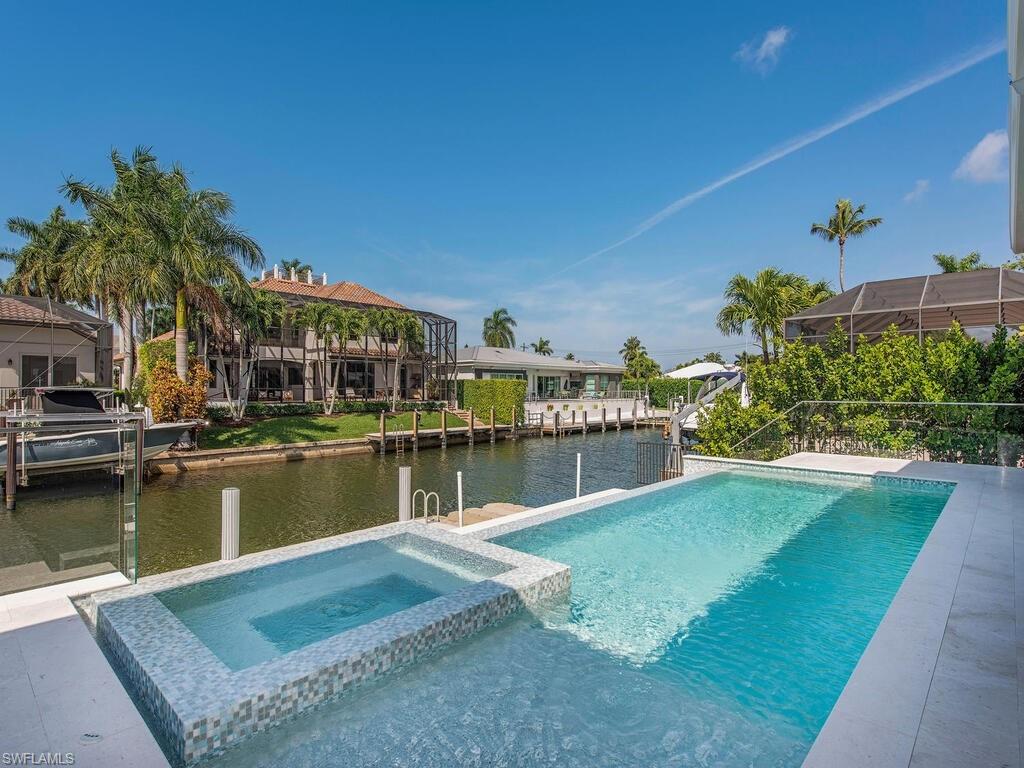 1840 Sandpiper Street Naples, FL 34102 - Photo 11 of 11 a view of a lake with a house