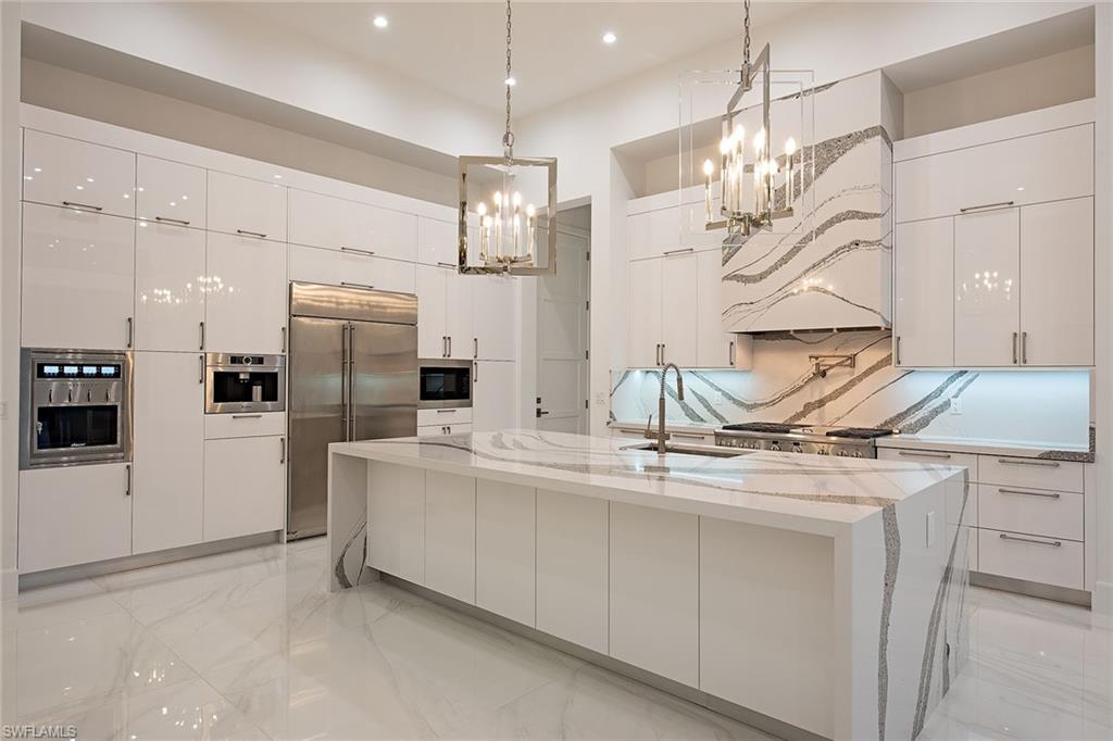1840 Sandpiper Street Naples, FL 34102 - Photo 2 of 11 a kitchen with stainless steel appliances kitchen island a refrigerator and a sink