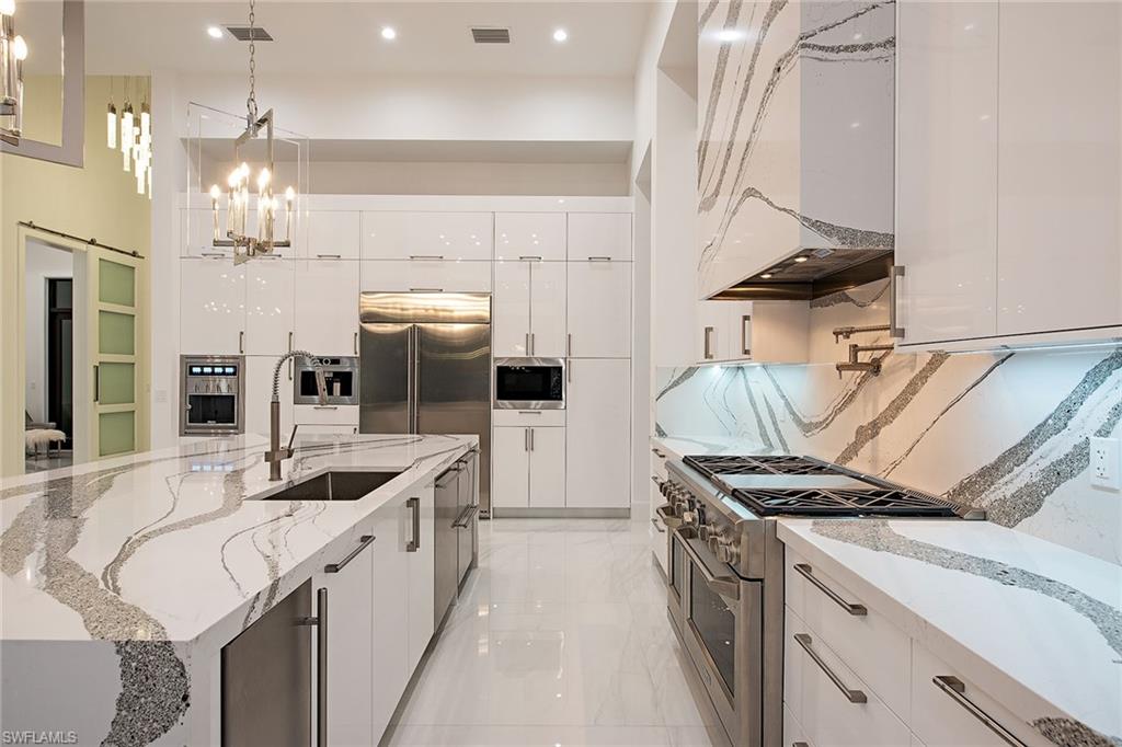 1840 Sandpiper Street Naples, FL 34102 - Photo 4 of 11 a kitchen that has a sink a stove and a table