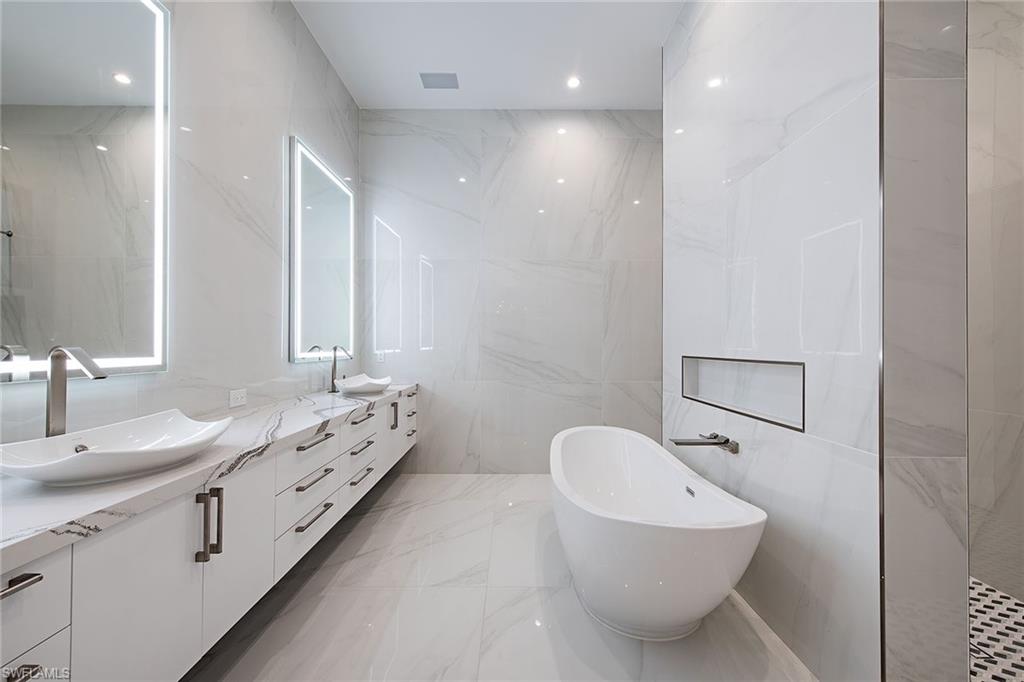 1840 Sandpiper Street Naples, FL 34102 - Photo 5 of 11 a bathroom with a double vanity sink mirror and toilet