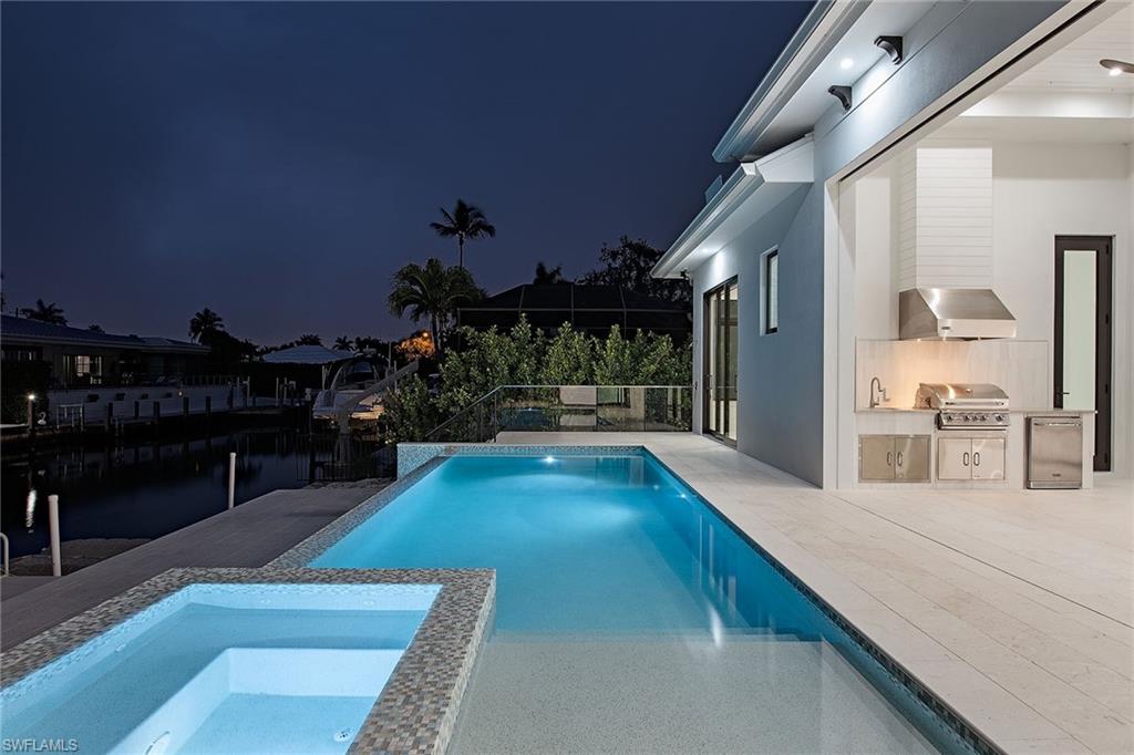 1840 Sandpiper Street Naples, FL 34102 - Photo 7 of 11 a view of living room and kitchen with furniture