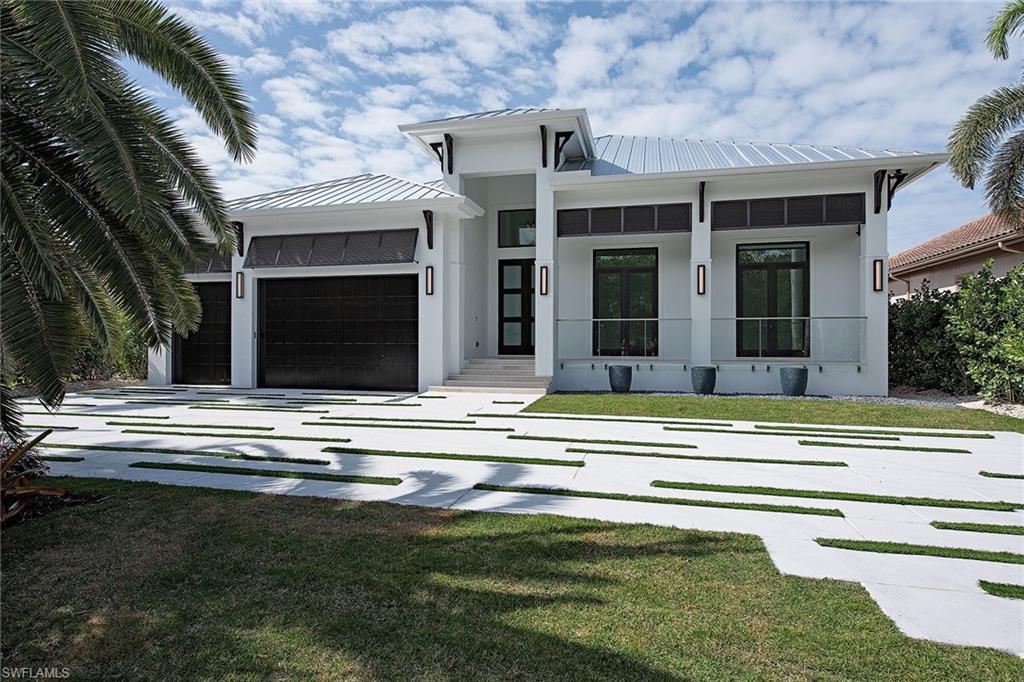 1840 Sandpiper Street Naples, FL 34102 - Photo 8 of 11 a view of a house with a swimming pool and a large window