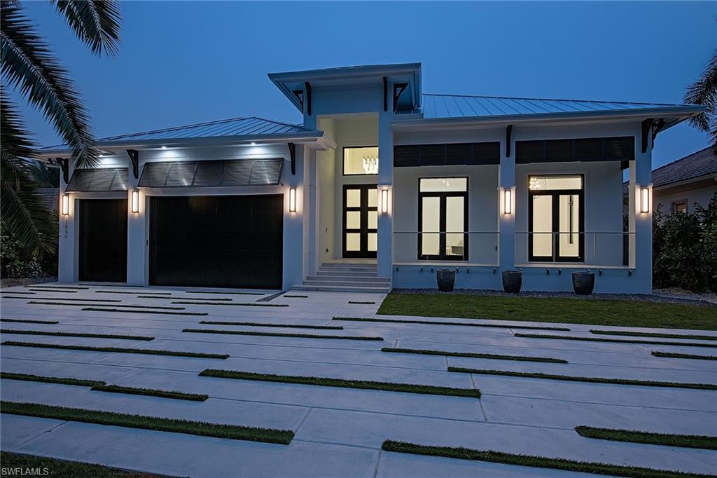 1840 Sandpiper Street Naples, FL 34102 - Photo 9 of 11 a front view of a house with a yard