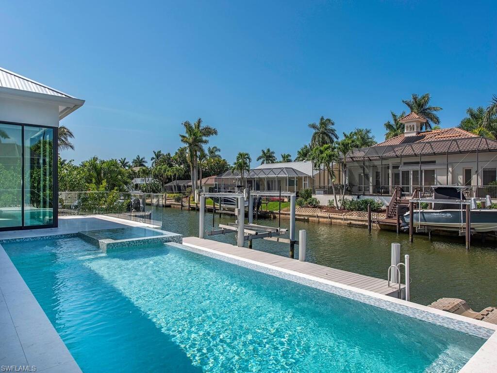 1840 Sandpiper Street Naples, FL 34102 - Photo 10 of 11 a view of a house with pool garden and lake view