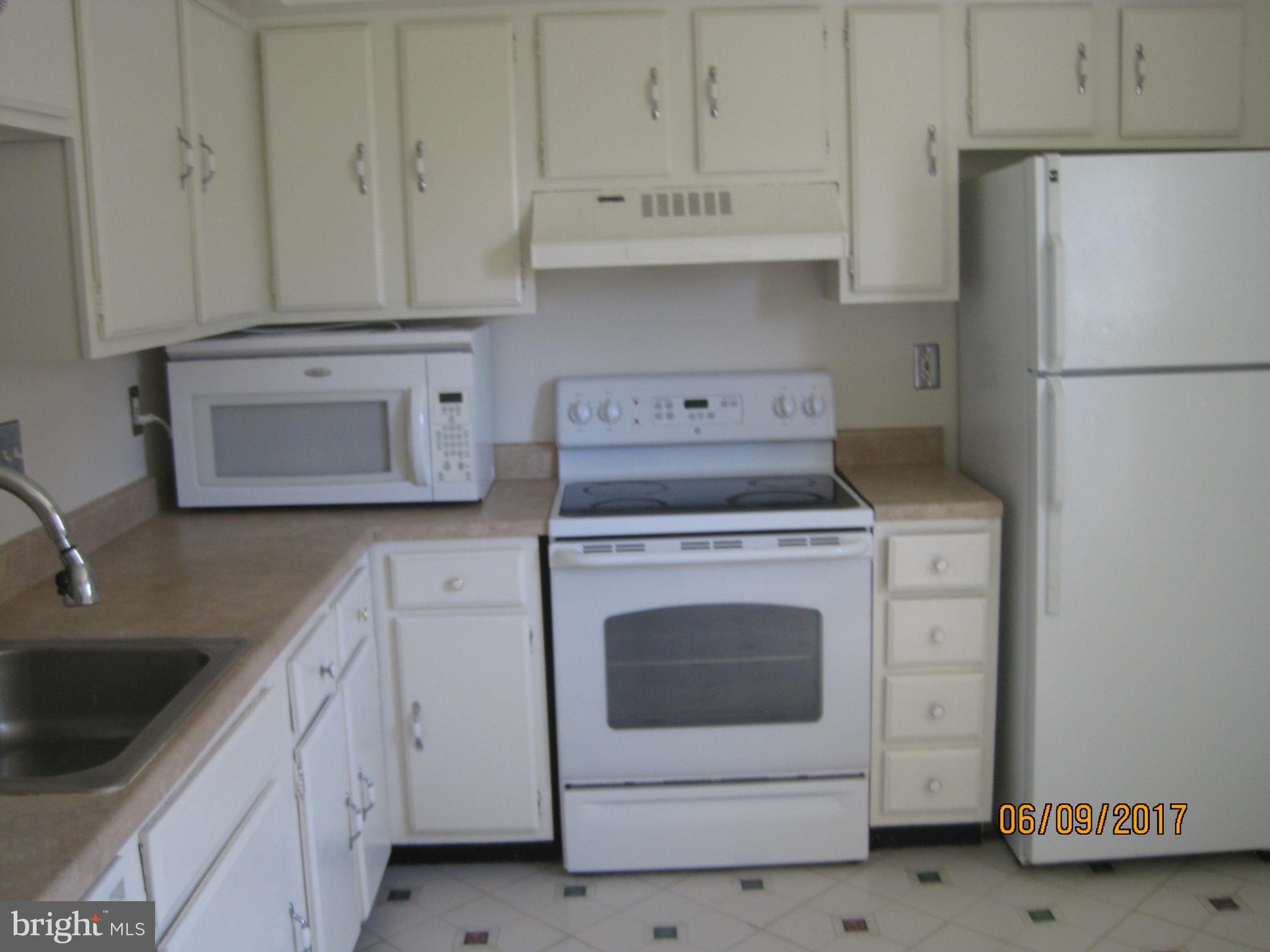 9640 Canterbury Riding, Unit 178 Laurel, MD 20723 - Photo 5 of 15 a kitchen with cabinets appliances and a sink