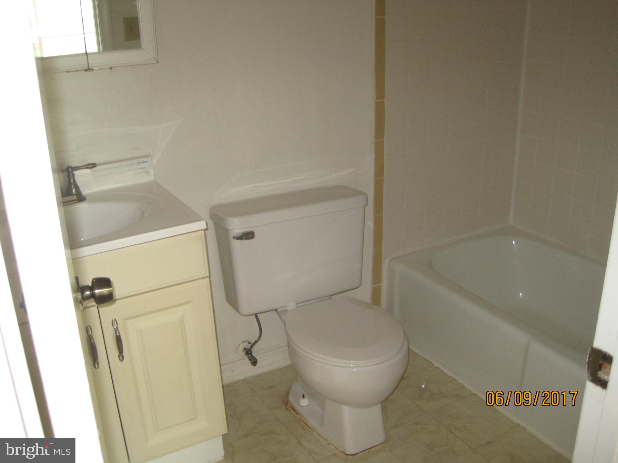 9640 Canterbury Riding, Unit 178 Laurel, MD 20723 - Photo 10 of 15 a white toilet sitting next to a bath tub
