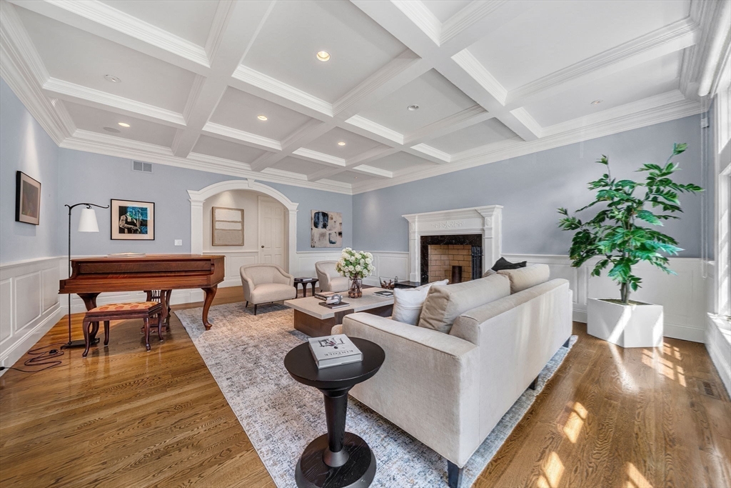 1 Stonefield Lane Wellesley, MA 02482 - Photo 11 of 30 a living room with furniture a fireplace and a table